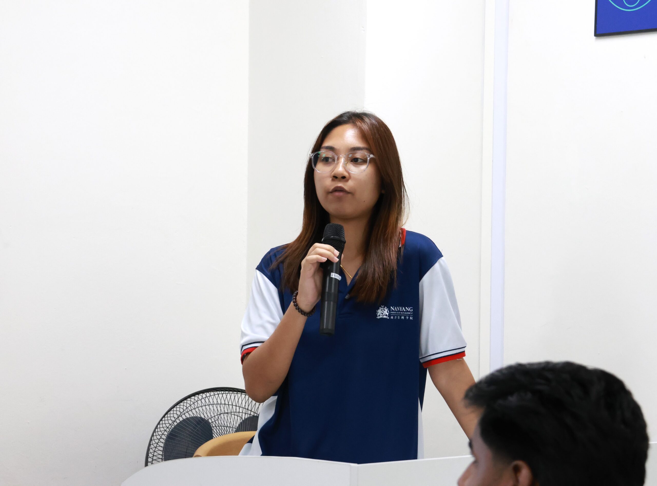 NIM Student Recruitment Executive, Ms. Qurratu, providing students with the student services.