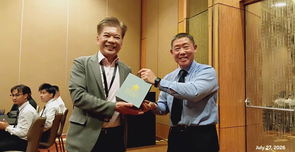 Mr Victor, NIM School of Tourism lecturer, handing the gift to Director of Technical Services, Mr Jamie Pang