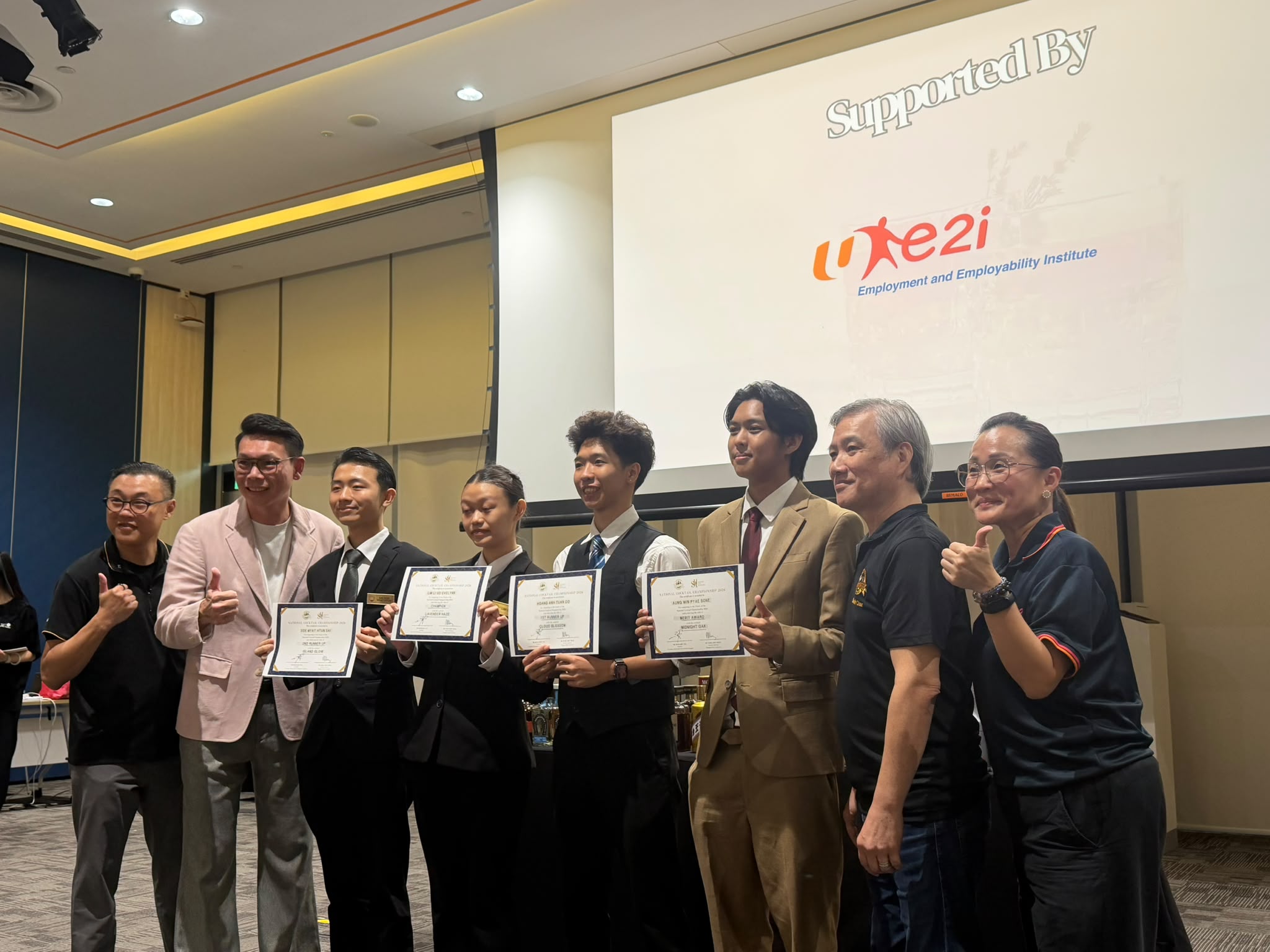 Win Oo proudly poses with his Merit Award following his success at the National Cocktail Competition.